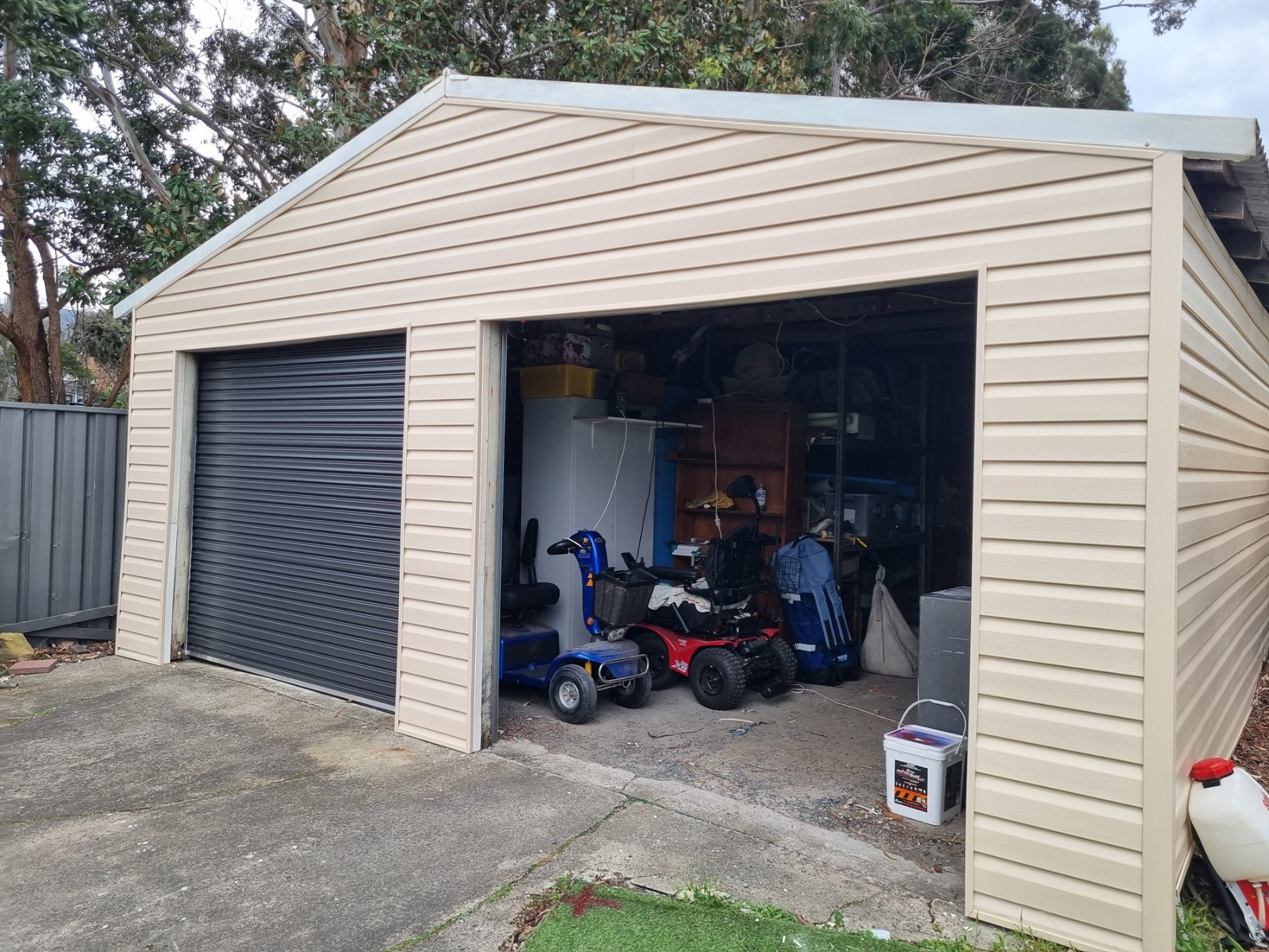 After: Garage re-clad in vinyl cladding with new roller door
